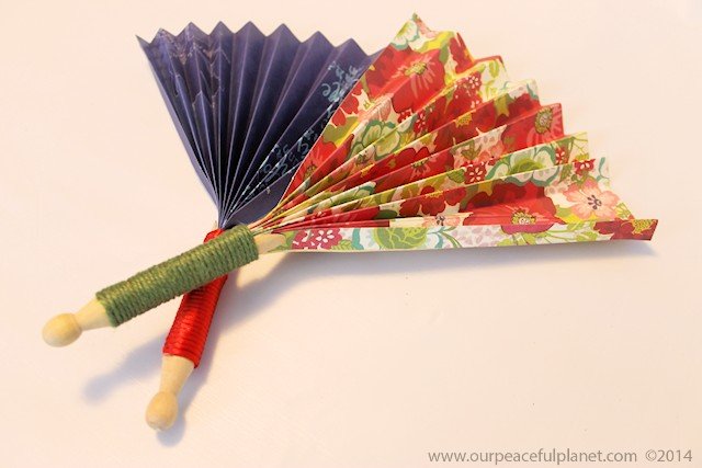 Make these quick hand fans in minutes using a regular wood clothespin and some heavy scrapbook paper. Wrap a little ribbon or twine around them and you have a beautiful way to cool off!