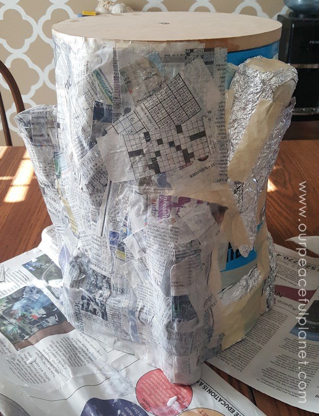 Add some whimsy to your home with this DIY tree stump stool. Remember using paper mache in grammar school? That's what creates the stump effect and it's easier than you think!