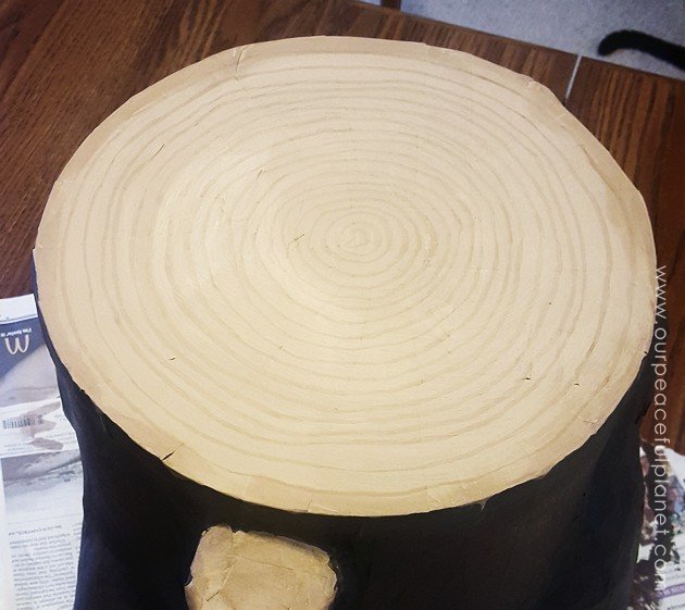 Add some whimsy to your home with this DIY tree stump stool. Remember using paper mache in grammar school? That's what creates the stump effect and it's easier than you think!
