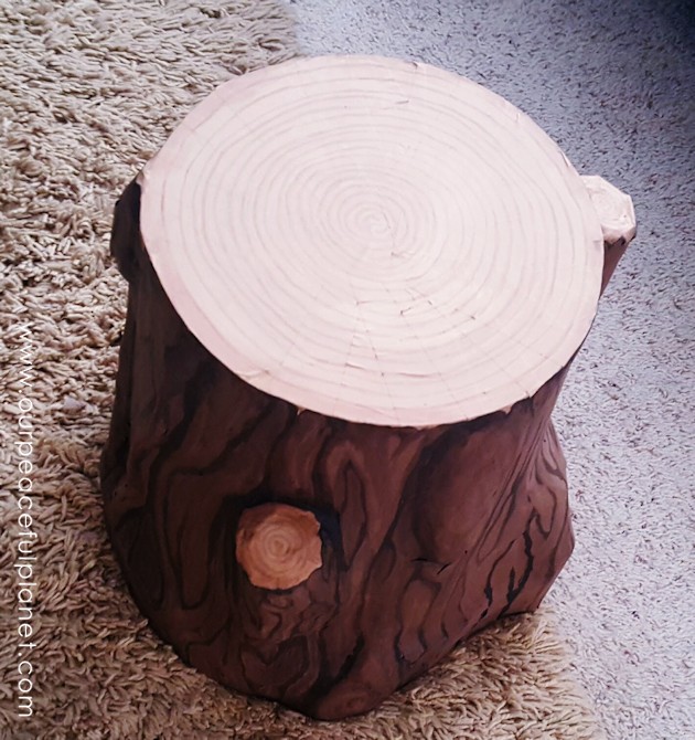 Add some whimsy to your home with this DIY tree stump stool. All you need is a 5 gallon bucket, wood circle, TP tubes, paper mache, foil and paint!