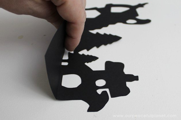 Grab the free printables and make these unique and inexpensive paper town shelf sitters! They will add a bit of whimsy to any room and only cost pennies.