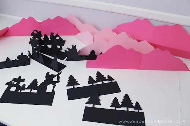 Grab the free printables and make these unique and inexpensive paper town shelf sitters! They will add a bit of whimsy to any room and only cost pennies.