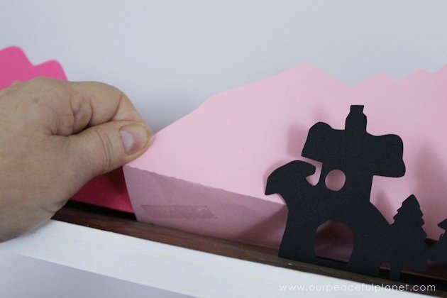 Grab the free printables and make these unique and inexpensive paper town shelf sitters! They will add a bit of whimsy to any room and only cost pennies.