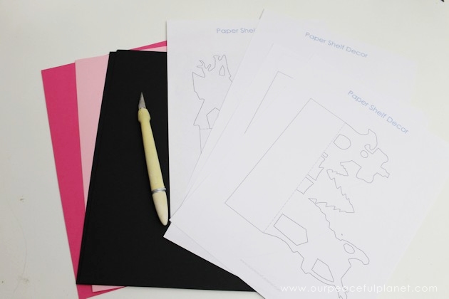 Grab the free printables and make these unique and inexpensive paper town shelf sitters! They will add a bit of whimsy to any room and only cost pennies.