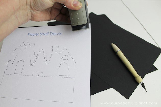 Grab the free printables and make these unique and inexpensive paper town shelf sitters! They will add a bit of whimsy to any room and only cost pennies.