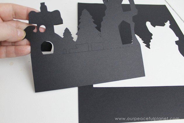 Grab the free printables and make these unique and inexpensive paper town shelf sitters! They will add a bit of whimsy to any room and only cost pennies.