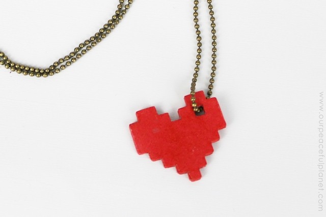 This pixel heart necklace is incredibly easy to make. All you need is some cardstock, glue and our free pattern. You'll be wearing retro jewelry in no time!
