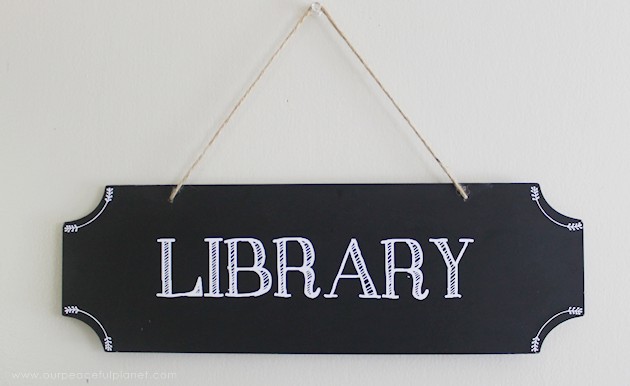 We made a simple room divider and turned a laundry room into a laundry slash home library that has a global feel and you won't believe how easy it was!