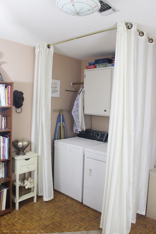 We made a simple room divider and turned a laundry room into a laundry slash home library that has a global feel and you won't believe how easy it was!