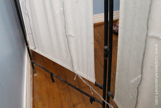 You can never have too many twinkle lights! Learn how to transform a plain room divider into something magical with some twinkle lights and safety pins!