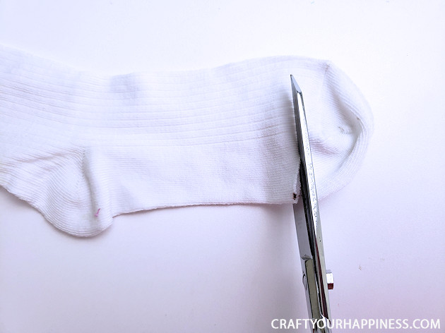A 10 minute simple no-sew face mask made from a sock and filter material will help protect you and those you love from the spread of COVID-19.