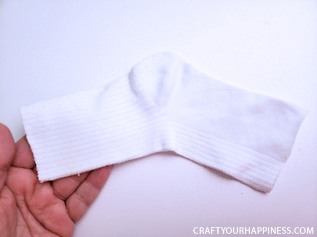 A 10 minute simple no-sew face mask made from a sock and filter material will help protect you and those you love from the spread of COVID-19.
