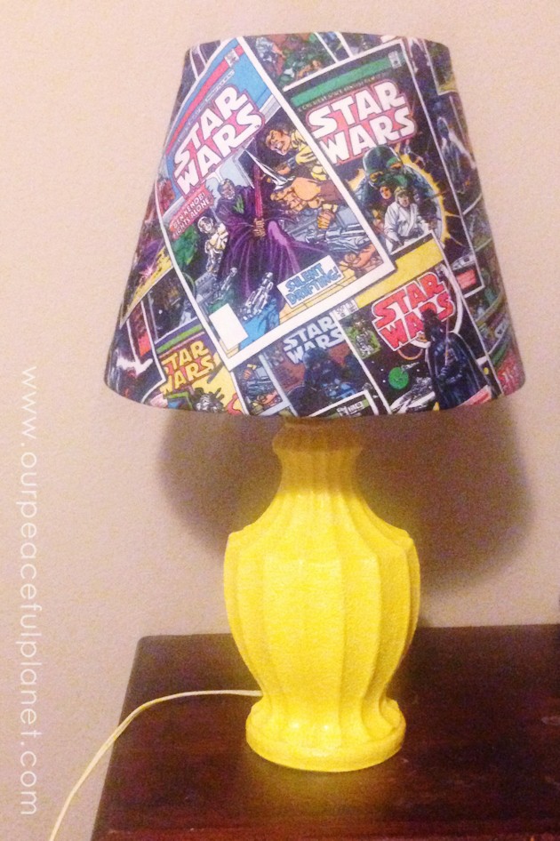 This trendy Star Wars lamp is easy to make and costs very little. All you need is an old lamp, spray paint, Mod Podge and some Star Wars material. 