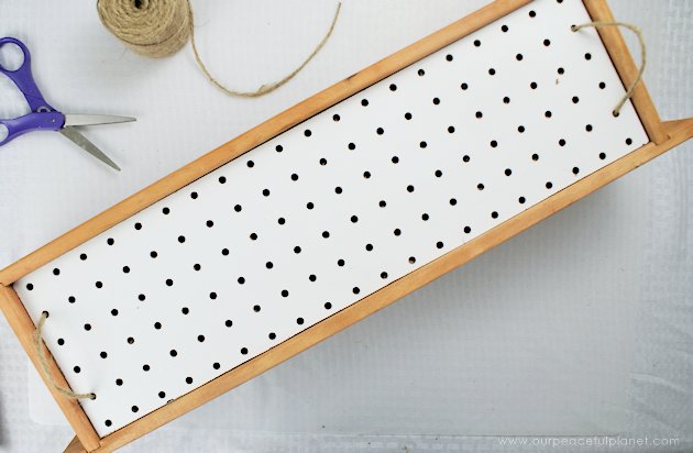 This DIY table centerpiece allows you to change decor year round for any occasion. Then lift out the pegboard insert to find candles for ambient lighting!