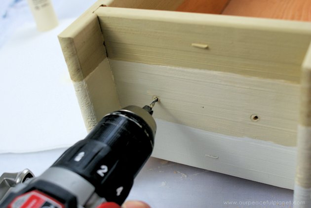 This DIY table centerpiece allows you to change decor year round for any occasion. Then lift out the pegboard insert to find candles for ambient lighting!