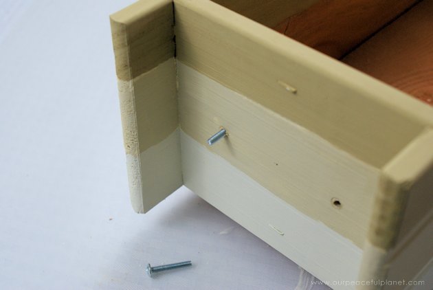 This DIY table centerpiece allows you to change decor year round for any occasion. Then lift out the pegboard insert to find candles for ambient lighting!