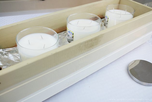 This DIY table centerpiece allows you to change decor year round for any occasion. Then lift out the pegboard insert to find candles for ambient lighting!