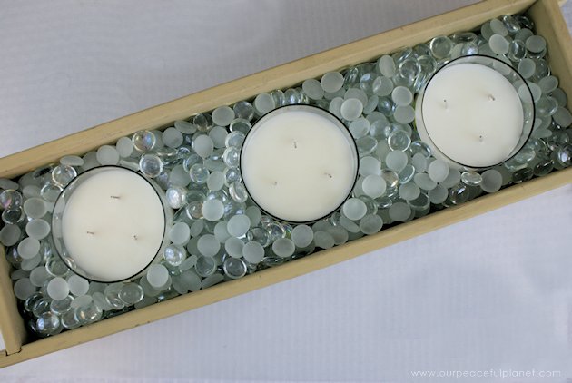 This DIY table centerpiece allows you to change decor year round for any occasion. Then lift out the pegboard insert to find candles for ambient lighting!