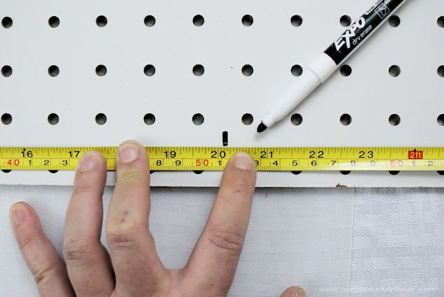 This DIY table centerpiece allows you to change decor year round for any occasion. Then lift out the pegboard insert to find candles for ambient lighting!