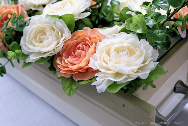 This DIY table centerpiece allows you to change decor year round for any occasion. Then lift out the pegboard insert to find candles for ambient lighting!
