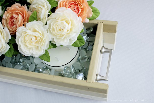 This DIY table centerpiece allows you to change decor year round for any occasion. Then lift out the pegboard insert to find candles for ambient lighting!