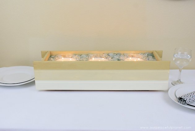 This DIY table centerpiece allows you to change decor year round for any occasion. Then lift out the pegboard insert to find candles for ambient lighting!