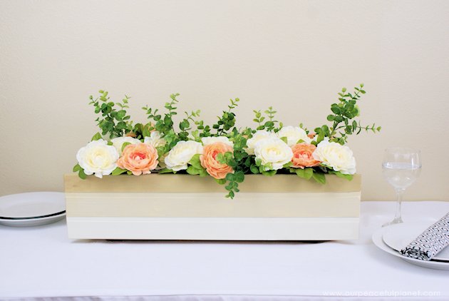 This DIY table centerpiece allows you to change decor year round for any occasion. Then lift out the pegboard insert to find candles for ambient lighting!