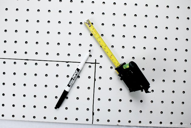 This DIY table centerpiece allows you to change decor year round for any occasion. Then lift out the pegboard insert to find candles for ambient lighting!