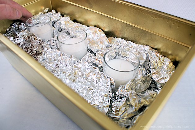 This DIY table centerpiece allows you to change decor year round for any occasion. Then lift out the pegboard insert to find candles for ambient lighting!