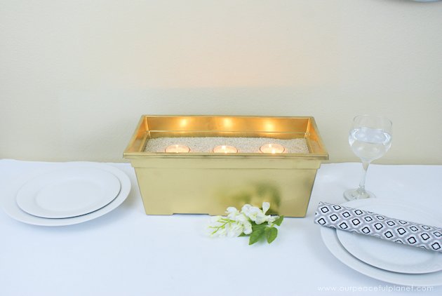 This DIY table centerpiece allows you to change decor year round for any occasion. Then lift out the pegboard insert to find candles for ambient lighting!