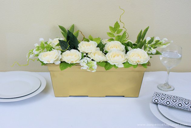 This DIY table centerpiece allows you to change decor year round for any occasion. Then lift out the pegboard insert to find candles for ambient lighting!