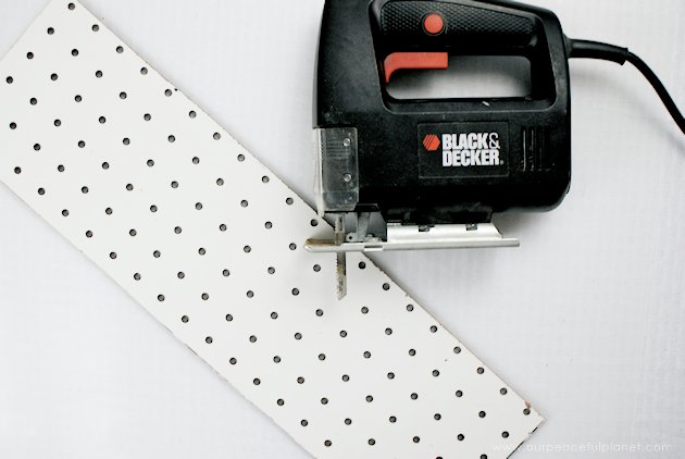 This DIY table centerpiece allows you to change decor year round for any occasion. Then lift out the pegboard insert to find candles for ambient lighting!
