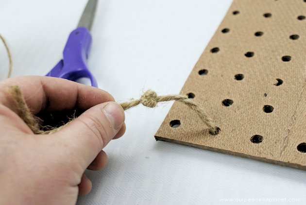 This DIY table centerpiece allows you to change decor year round for any occasion. Then lift out the pegboard insert to find candles for ambient lighting!