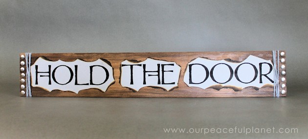 This simple medieval "Hold the Door" sign is part of our Over the Door Decor series. Easy plaques you create to send you out the door with a smile. 