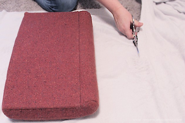 Watch how two $2 thrift store office chairs were transformed into a gorgeous comfy bench seat with nothing more than some paint and $6.00 of material.