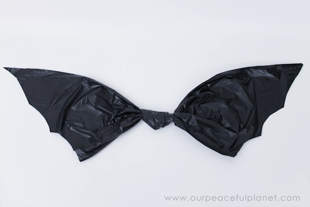 Need quick, low cost awesome looking Halloween decorations? Go to your cupboard, grab some black plastic trash bags & make a large creepy bat in 5 minutes!