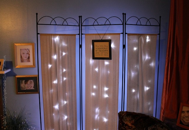 You can never have too many twinkle lights! Learn how to transform a plain room divider into something magical with some twinkle lights and safety pins!