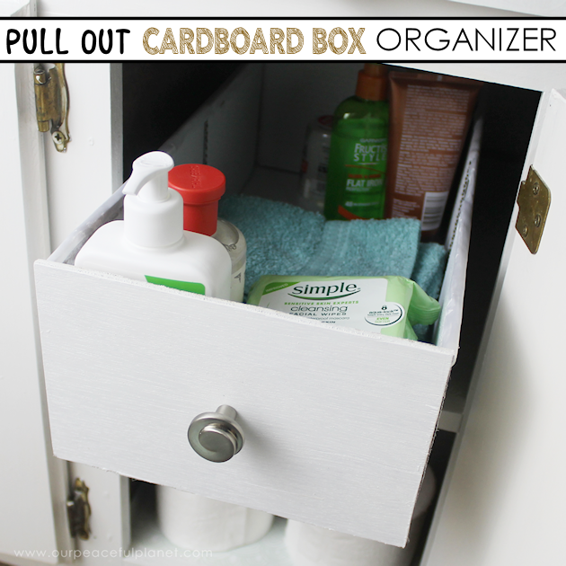 Learn how to make an inexpensive pull out cabinet organizer using a cardboard box so you can easily access things in the far reaches of your lower cabinets. 