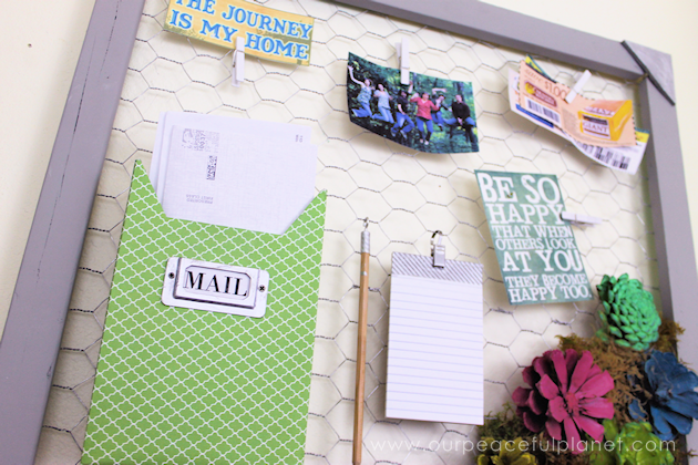 A country chicken wire frame memo board that will brighten up your kitchen with its pretty pinecone succulents. It holds useful items plus photos & quotes!