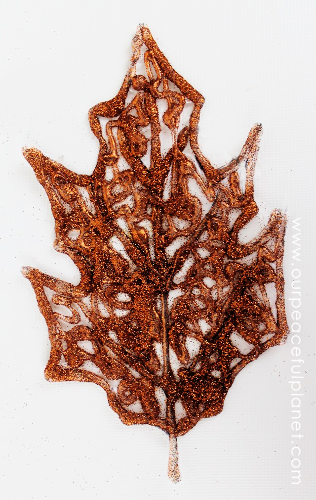 Make these beautiful DIY fall decorations with a glue gun and some glitter! Use the leaves in table settings, wall hangings or any other fall decor item.