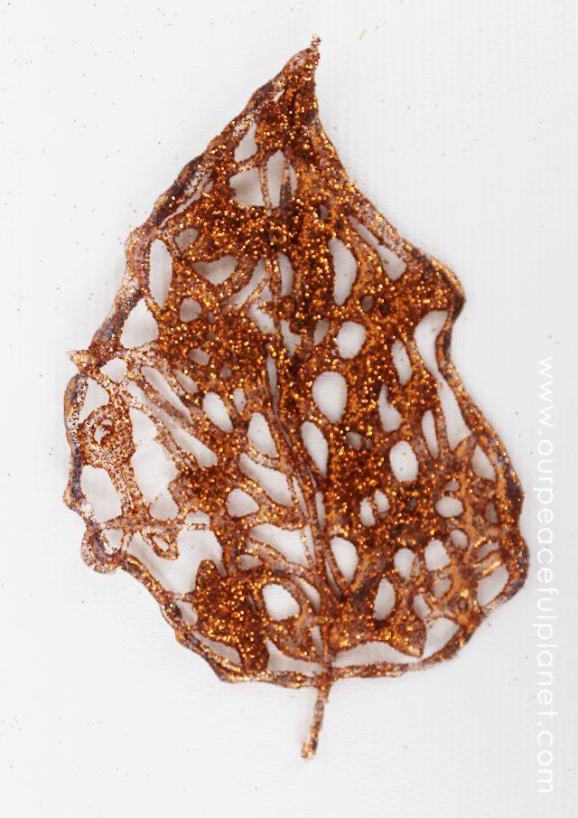 Make these beautiful DIY fall decorations with a glue gun and some glitter! Use the leaves in table settings, wall hangings or any other fall decor item.