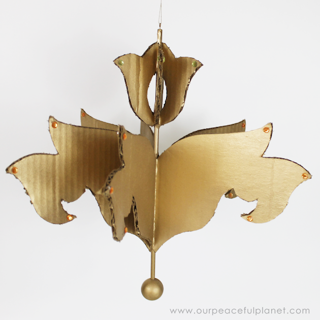Add a little whimsy to any room with a cardboard chandelier! Grab our free pattern, some cardboard , a hot glue gun and paint. Add any bling you like! 