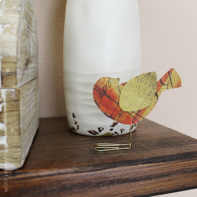 These sweet little birdies are perfect for a touch of whimsy DIY room decor and they can be placed in any room you like! Sit them on shelves, mantles, on top of books... you can even put a row on top of a door jam! Using our pattern you can make whatever colors you like. All you need is the paper of your choice and two paperclips and glue.
