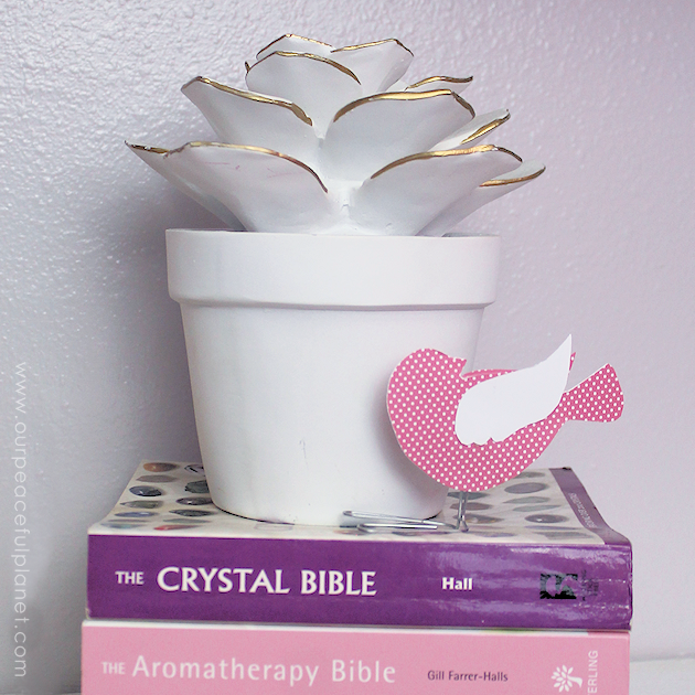 These sweet little birdies are perfect for a touch of whimsy DIY room decor and they can be placed in any room you like! Sit them on shelves, mantles, on top of books... you can even put a row on top of a door jam! Using our pattern you can make whatever colors you like. All you need is the paper of your choice and two paperclips and glue.