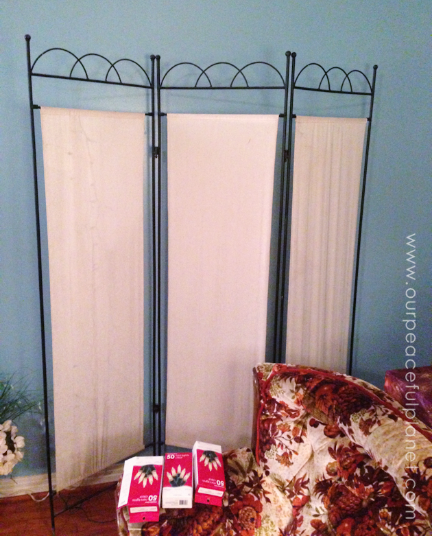You can never have too many twinkle lights! Learn how to transform a plain room divider into something magical with some twinkle lights and safety pins!